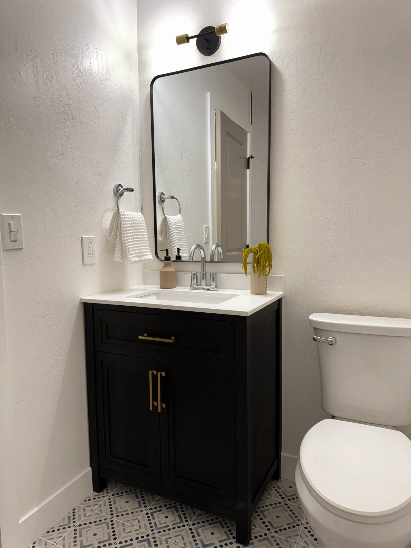 Bathroom with black vanity and modern fixtures