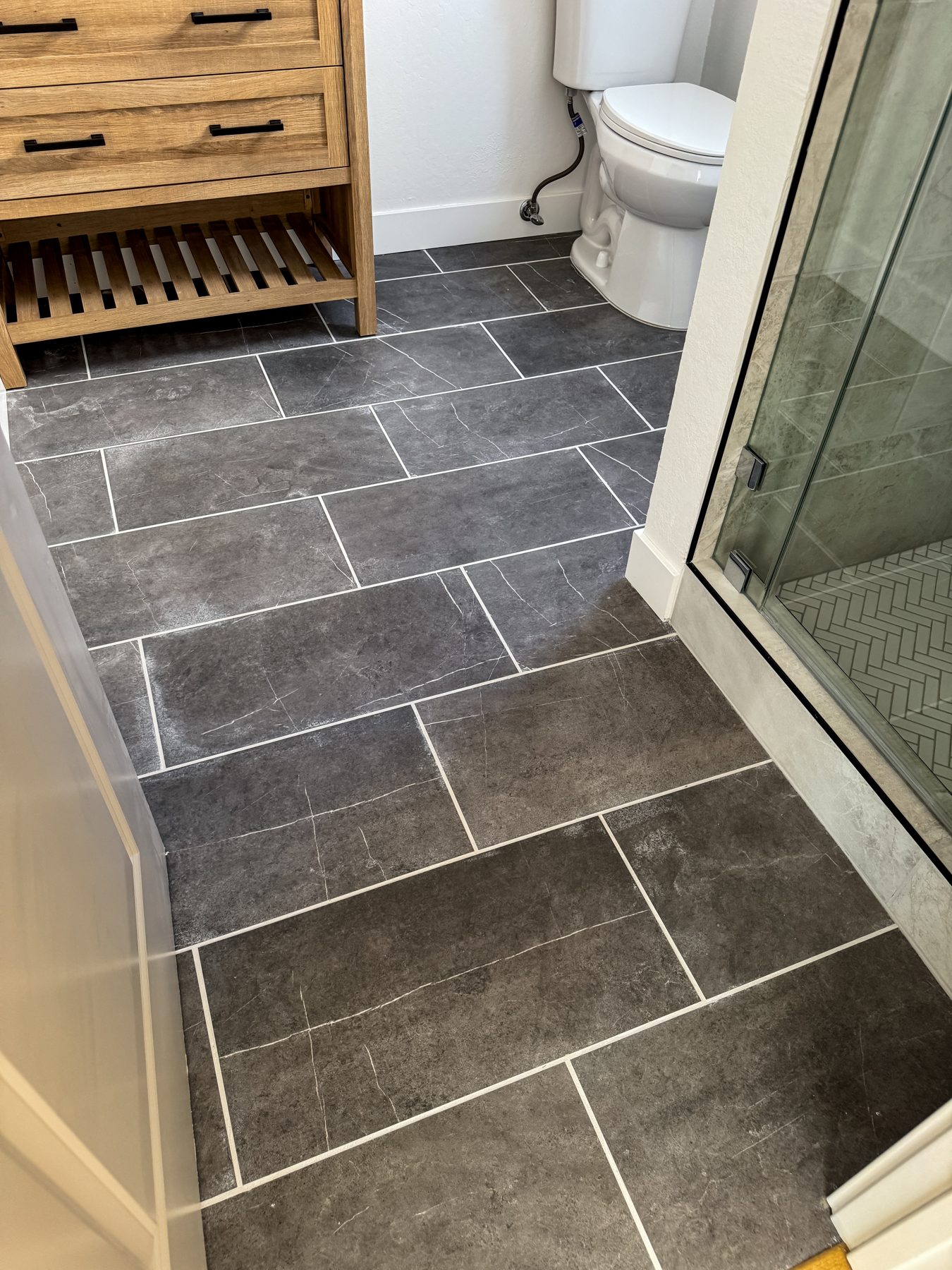 Finished Martinez bathroom floor tile and glass shower