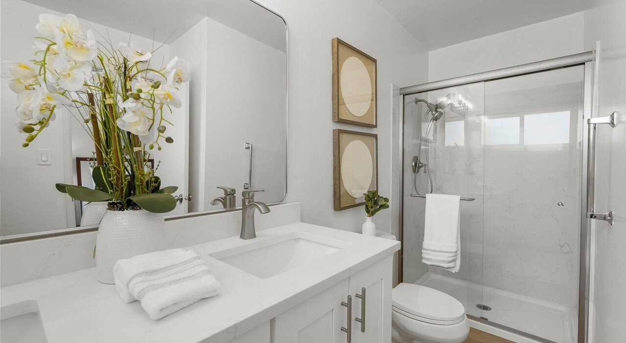 Douglass Street bathroom with a glass shower and white vanity
