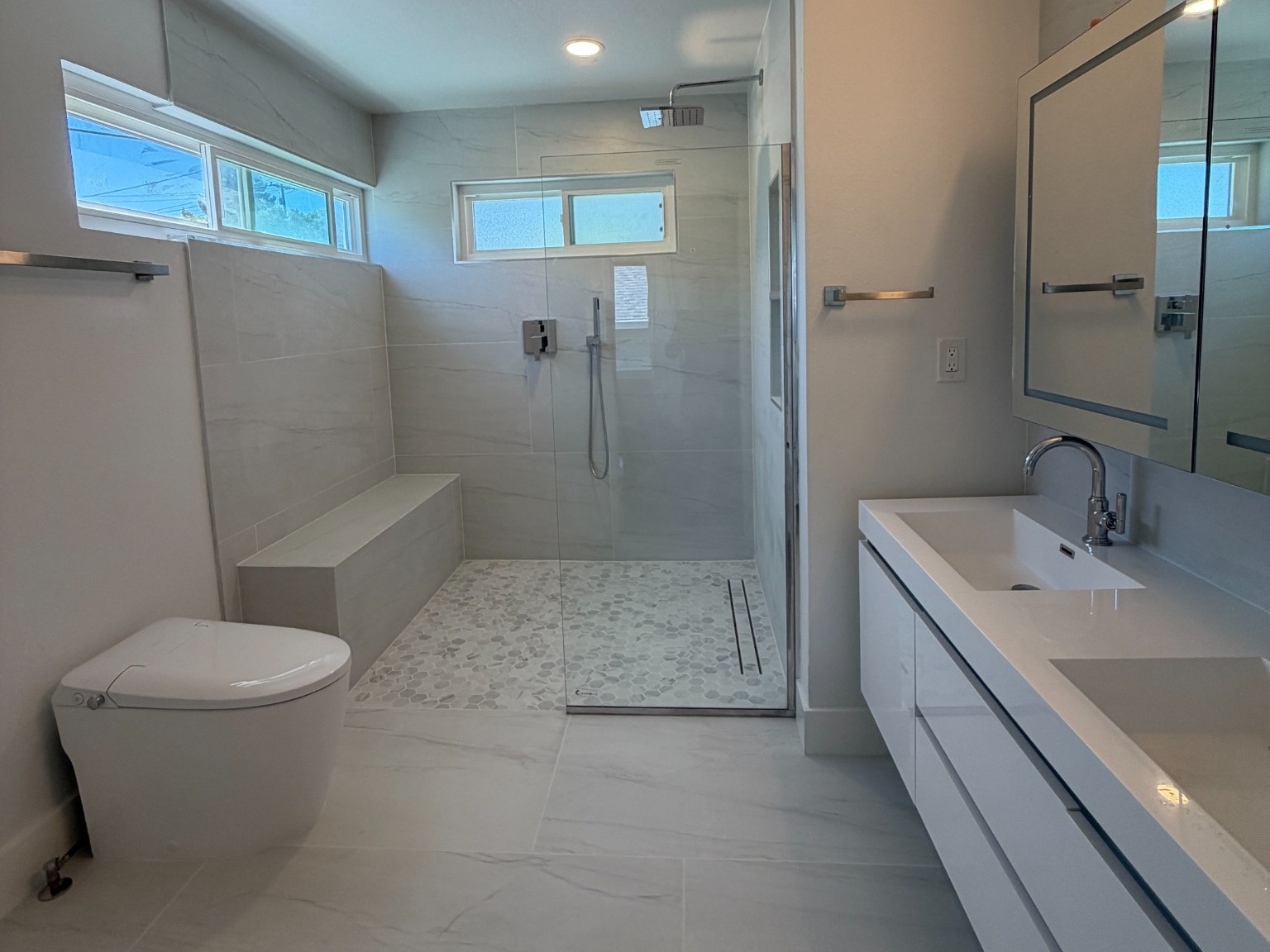 Castro Valley three-bathroom remodel primary bathroom with walk-in shower, toilet, and double vanity