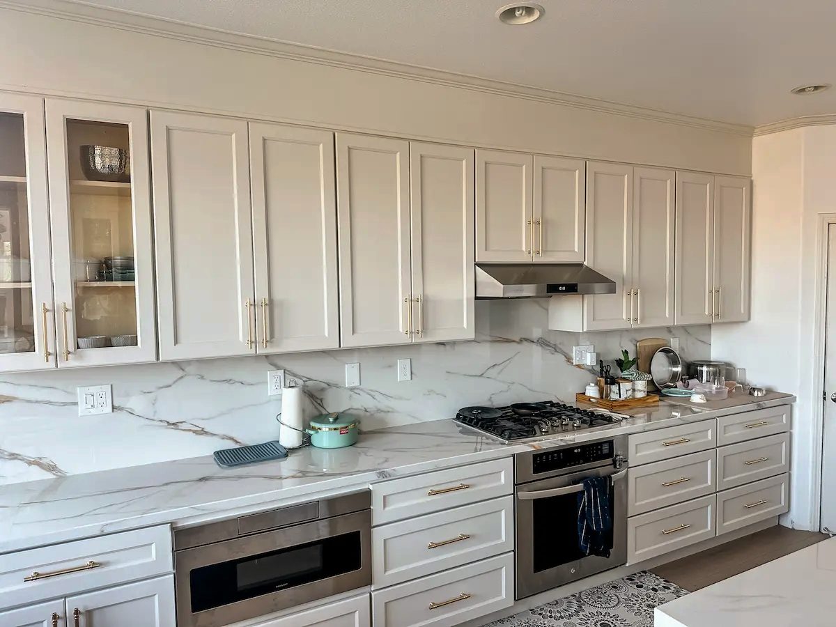 Completed Livermore kitchen with white cabinets and stone-look surfaces