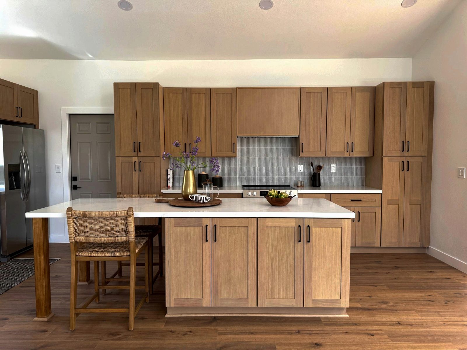 Completed Martinez kitchen with warm wood cabinetry and a central island